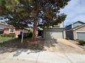 Charming two-story home with attached garage and mature tree in the front yard at 8034 Decatur St, Westminster, CO 80031