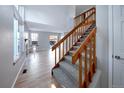 Open living room with staircase, light hardwood floors, fireplace, and lots of natural light at 8034 Decatur St, Westminster, CO 80031
