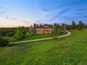 Exterior view of luxurious home with a long driveway at 5602 Silver Bluff Ct, Parker, CO 80134
