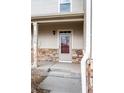 Inviting front entryway with stone accents, a covered porch, and the house number clearly displayed at 12715 E 104Th Pl, Commerce City, CO 80022