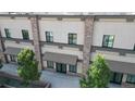 View of the building's exterior, highlighting the stone columns and neutral-colored facade with shade awning at 615 24Th St # 104, Golden, CO 80401
