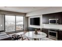 Bright living room with large windows, a modern kitchen, and comfortable seating area at 1643 Boulder St # 209, Denver, CO 80211