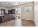 Open kitchen with dark wood cabinets, stainless steel appliances, and hardwood floors at 1299 Osceola St, Denver, CO 80204