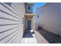 Home exterior showcasing the front entrance with a view of the side yard at 814 N Bently St, Watkins, CO 80137
