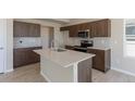 A kitchen featuring wooden cabinets, granite countertops, and stainless steel appliances at 814 N Bently St, Watkins, CO 80137