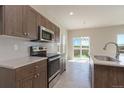Spacious kitchen with stainless steel appliances and natural light at 814 N Bently St, Watkins, CO 80137