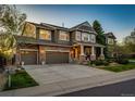 Inviting two-story home with a stone facade, covered front porch, and beautifully landscaped yard at 4307 Lilly Gulch Trl, Castle Rock, CO 80109