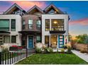 Contemporary two-story home with brick and white walls, a green lawn, and blue doors at 2257 S High St, Denver, CO 80210