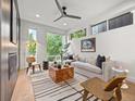 Bright living room featuring hardwood floors, stylish furniture, and large windows with outdoor views at 3715 Kalamath St, Denver, CO 80211