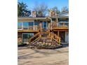 Close-up of a two-story home exterior featuring stone accents, a wooden deck, and a welcoming front entrance at 8090 Newton St, Westminster, CO 80031