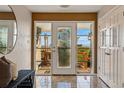Elegant foyer featuring a decorative front door with sidelights, tile floors, and views of the outdoor deck at 8090 Newton St, Westminster, CO 80031