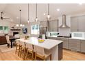 Spacious kitchen featuring a large island with barstool seating and modern stainless steel appliances at 4711 S Logan St, Englewood, CO 80113