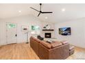 Bright living room features a leather sectional sofa, fireplace, and hardwood floors at 4711 S Logan St, Englewood, CO 80113