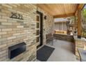 Inviting front porch featuring brick accents, stylish bench seating, and an elegant entrance door at 2521 N Gaylord St, Denver, CO 80205