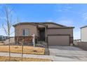 Charming single Gathering house showcasing stone accents, a two-car garage, well maintained lawn, and an inviting front porch at 18001 Herrera Dr, Parker, CO 80134