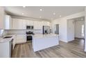 Eat-in kitchen with stainless steel appliances, ample counter space, and bright lighting at 5581 Inland Ave, Firestone, CO 80504