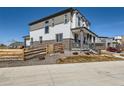 Stylish two-story home with a fenced yard and inviting covered porch at 10723 Sedalia St, Commerce City, CO 80022