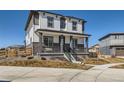Attractive two-story home showcasing a covered front porch and well-maintained landscaping at 10723 Sedalia St, Commerce City, CO 80022