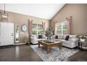 Elegant living room featuring vaulted ceilings, two sofas, and natural light at 13087 Krameria St, Thornton, CO 80602