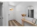 Bright foyer featuring wood floors, a decorative mirror and console table at 13408 Wabash St, Thornton, CO 80602