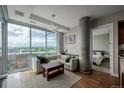 Bright living room features city views from floor-to-ceiling windows and modern lighting fixture at 4200 W 17Th Ave # 625, Denver, CO 80204