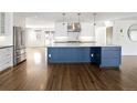 Stylish kitchen island features a marble countertop, custom blue cabinetry, and modern fixtures at 2025 Ash St, Denver, CO 80207