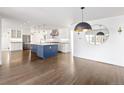 Bright, open kitchen layout with a large island, stainless appliances, and hardwood flooring at 2025 Ash St, Denver, CO 80207