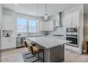 Bright kitchen features a large island, stainless appliances, and ample storage at 2282 Old Rail Way, Superior, CO 80027