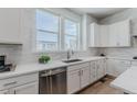 This kitchen includes stainless steel appliances, light countertops and ample natural light at 2282 Old Rail Way, Superior, CO 80027