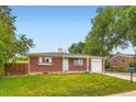 Charming single story brick home with a well-maintained lawn and an attached one car garage at 11891 Gaylord Way, Northglenn, CO 80233