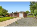 Charming brick single-story home with a well-manicured front yard and driveway leading to an attached garage at 11891 Gaylord Way, Northglenn, CO 80233