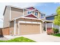 Beautiful two-story home featuring a spacious two-car garage and a cozy front porch, perfect for relaxation at 9927 Aftonwood St, Highlands Ranch, CO 80126