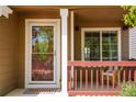 Charming front porch with decorative railing, a welcoming door, and a cozy seating area, perfect for enjoying quiet moments at 9927 Aftonwood St, Highlands Ranch, CO 80126