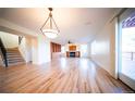 Bright living room featuring hardwood floors, a fireplace, built-in bookshelves and sliding door access to deck at 1674 Bent Grass Cir, Castle Rock, CO 80109