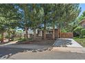 Charming two-story home featuring a stone facade, mature trees, a private driveway, and welcoming curb appeal at 9350 Raleigh Ct, Westminster, CO 80031