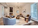 Relaxing living room showcases hardwood floors, recessed lights, neutral walls, and an eye-catching lighting fixture at 574 Agoseris Way, Castle Rock, CO 80104