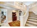Grand entry with staircase and antique furniture at 900 E Kenyon Ave, Cherry Hills Village, CO 80113