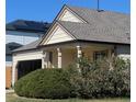Charming home with a covered porch, attached garage, and well-maintained landscaping at 20451 Kelly Pl, Denver, CO 80249