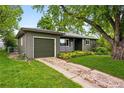 Lovely home with attached garage, lush lawn, and mature trees at 5436 E Atlantic Pl, Denver, CO 80222