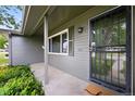 Charming front door with a security screen and well-kept landscaping at 5436 E Atlantic Pl, Denver, CO 80222