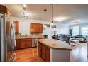 Bright kitchen featuring stainless steel appliances, a breakfast bar, hardwood floors and an open floor plan at 13456 Via Varra # 225, Broomfield, CO 80020