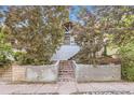 Charming two-story home with a brick staircase surrounded by mature trees and landscaped details at 3521 Osage St, Denver, CO 80211