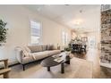 Bright living room with hardwood floors, a comfortable sofa, and an open view to the kitchen at 3521 Osage St, Denver, CO 80211