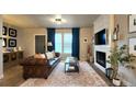 Cozy living room featuring a fireplace, comfortable seating, and stylish decor at 13640 Garfield St # A, Thornton, CO 80602