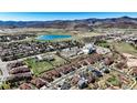 Expansive aerial view of a residential area with a scenic lake and mountain backdrop, offering a serene living environment at 5822 S Van Gordon Ln, Littleton, CO 80127