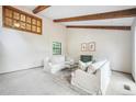 Bright living room featuring exposed beams, neutral decor, and ample natural light at 510 Silhouette Way, Monument, CO 80132