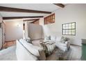 Comfortable living room with wood beams, neutral tones, and large windows at 510 Silhouette Way, Monument, CO 80132