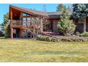 Gorgeous two-story home featuring a balcony and lush, landscaped front yard at 40 Charlou Cir, Cherry Hills Village, CO 80111