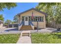 Charming home with inviting staircase and gravel landscaping under a clear sky at 3280 Fenton St, Wheat Ridge, CO 80212