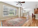 Bright living room with large windows, hardwood floors, and an open floor plan at 11972 W Long Cir # 104, Littleton, CO 80127